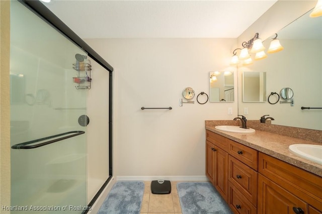 bathroom featuring tile patterned flooring, vanity, and an enclosed shower