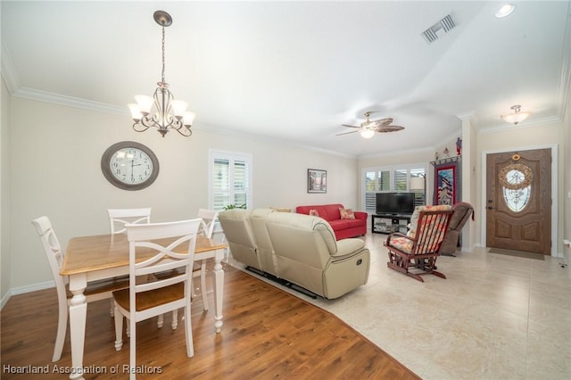 living room with crown molding, ceiling fan with notable chandelier, and light hardwood / wood-style floors