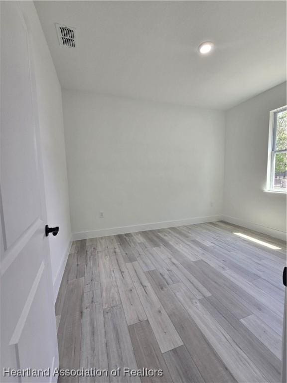 empty room with light hardwood / wood-style flooring