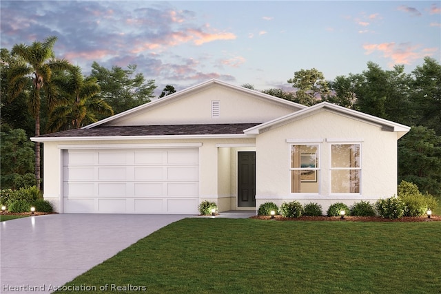 view of front of property featuring a garage and a lawn