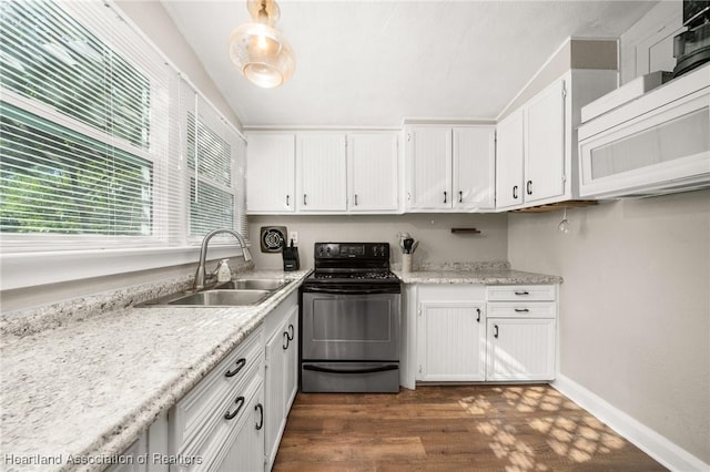 412 Rose Ave, Sebring, FL 33870 - kitchen with white microwave, range, white cabinets, dark wood-style flooring, and a sink