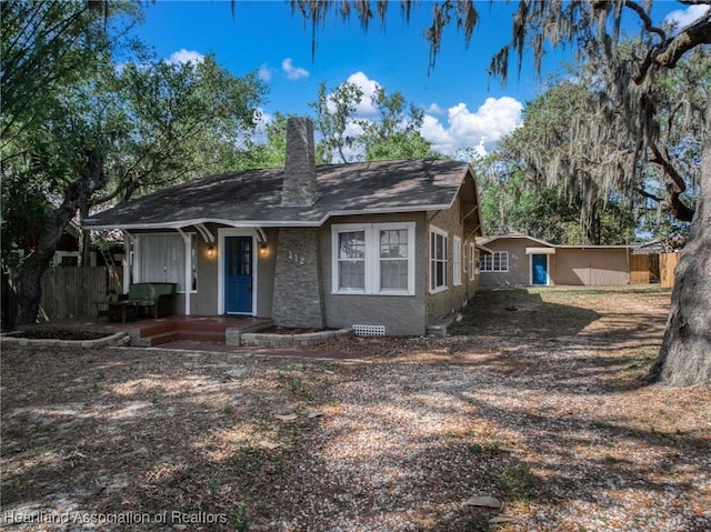 412 Rose Ave, Sebring, FL 33870 - bungalow featuring a chimney, fence, and a porch