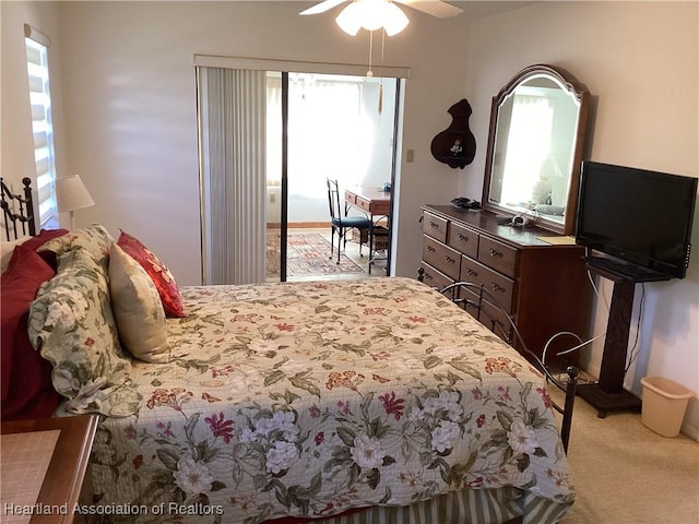 carpeted bedroom with access to exterior, multiple windows, and ceiling fan