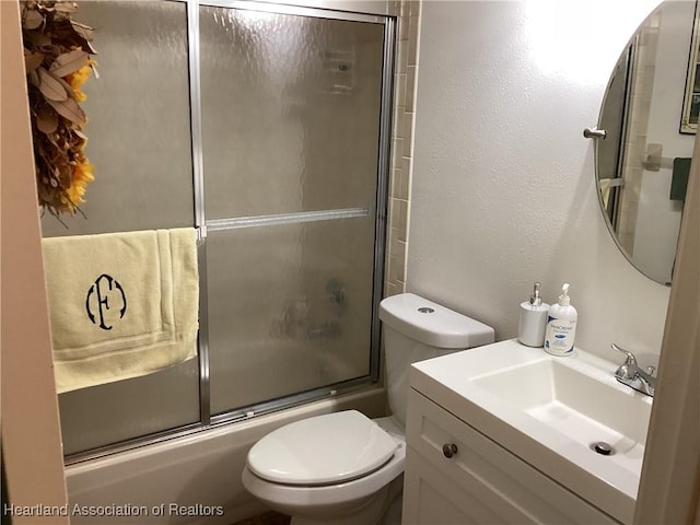 full bathroom with toilet, vanity, and combined bath / shower with glass door