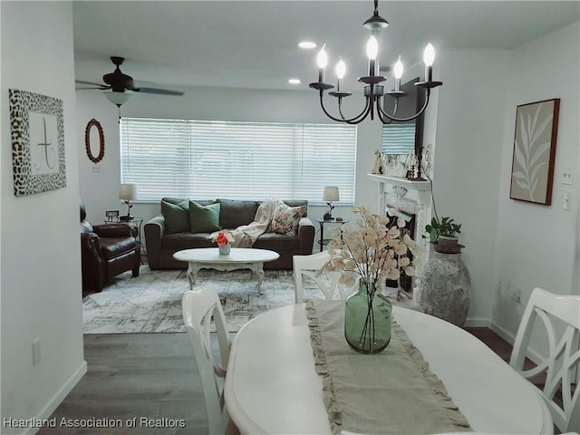 200 Robin Ave, Sebring, FL 33870 - dining space with a chandelier, wood finished floors, ceiling fan, and baseboards
