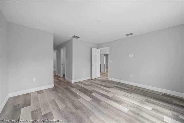 spare room featuring light wood-type flooring