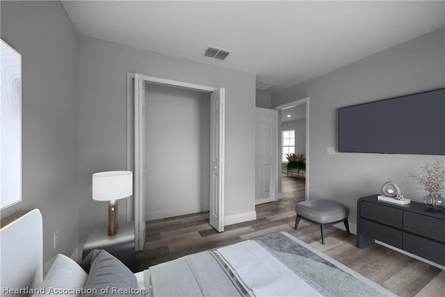 bedroom with dark wood-type flooring