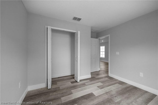 unfurnished bedroom featuring a closet and light hardwood / wood-style flooring