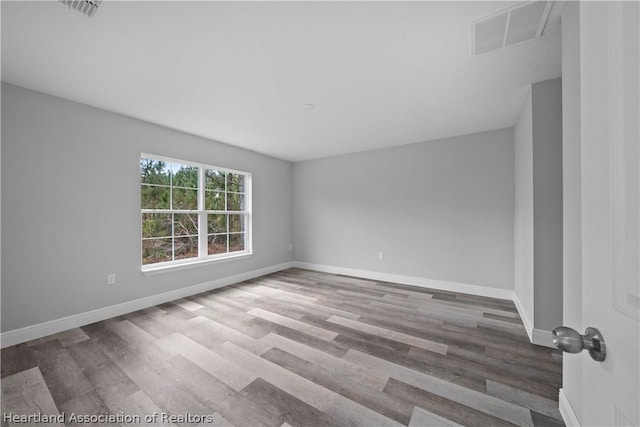 spare room with hardwood / wood-style flooring