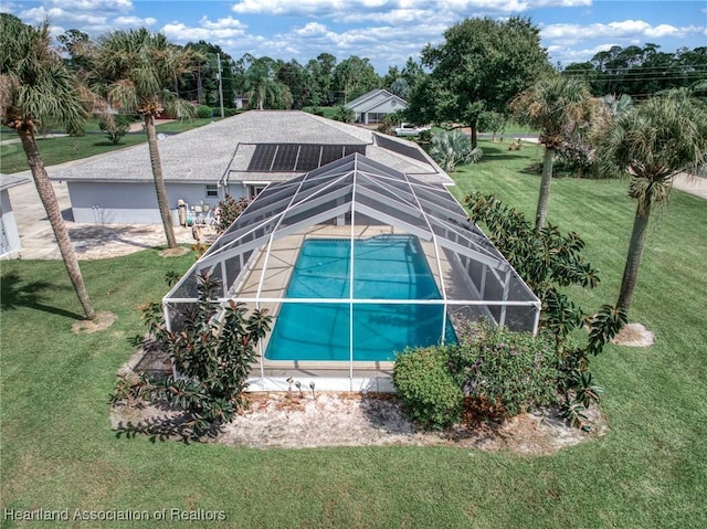 view of side of property featuring a lawn and a lanai