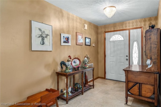 foyer entrance featuring a notable chandelier