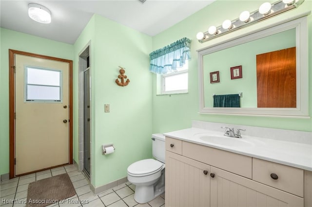 bathroom featuring tile patterned floors, vanity, toilet, and walk in shower