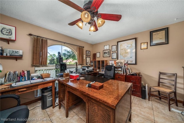 tiled office with a textured ceiling and ceiling fan