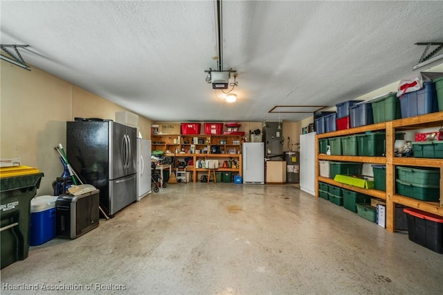 garage with a garage door opener, white fridge, electric water heater, and stainless steel refrigerator