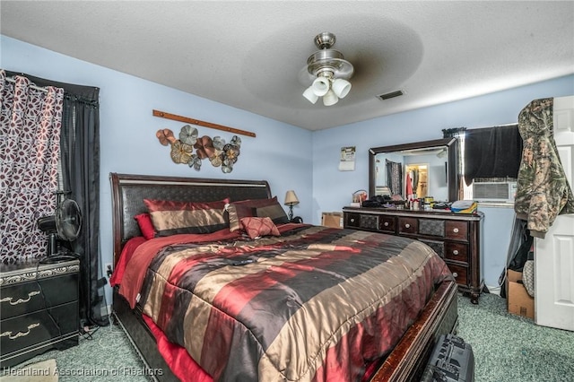 carpeted bedroom featuring ceiling fan, cooling unit, and a textured ceiling