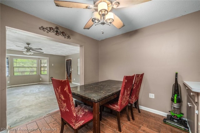 dining space featuring ceiling fan and hardwood / wood-style flooring