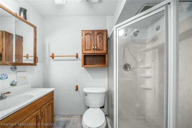 bathroom featuring tasteful backsplash, walk in shower, vanity, a textured ceiling, and toilet