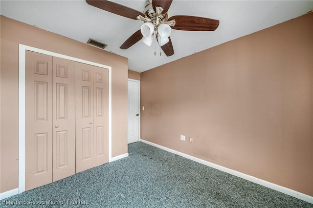 unfurnished bedroom with ceiling fan, a closet, and carpet