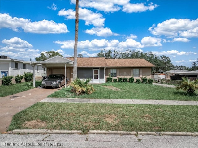 view of front of property with a carport and a front lawn