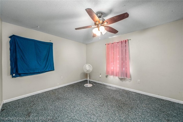 carpeted empty room with ceiling fan and a textured ceiling