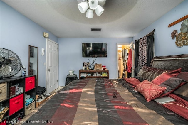 bedroom featuring a textured ceiling and ceiling fan