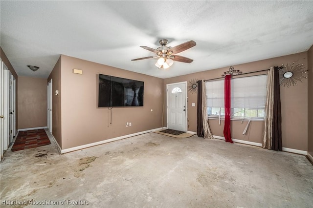 interior space featuring ceiling fan and concrete floors