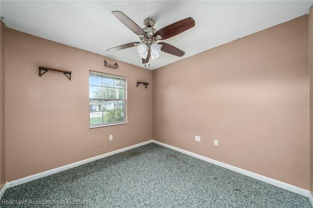 carpeted empty room with a textured ceiling and ceiling fan