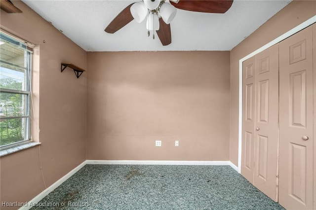 unfurnished room with carpet flooring and ceiling fan