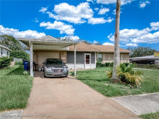 view of front facade with a front yard and a carport