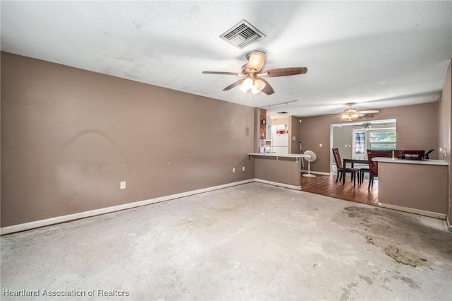 unfurnished living room with concrete floors