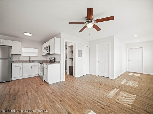 1802 E Claradge Ave, Avon Park, FL 33825 - kitchen featuring appliances with stainless steel finishes, a sink, light stone counters, ceiling fan, and light wood-style floors