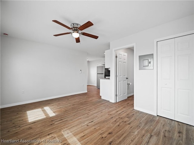 1802 E Claradge Ave, Avon Park, FL 33825 - unfurnished living room with ceiling fan, wood finished floors, and baseboards