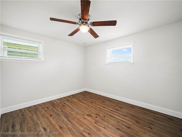 1802 E Claradge Ave, Avon Park, FL 33825 - spare room featuring baseboards, healthy amount of natural light, and dark wood-style floors