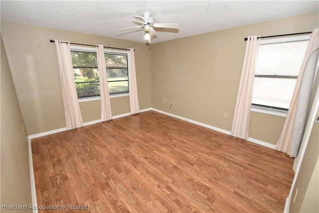 spare room featuring hardwood / wood-style flooring and ceiling fan