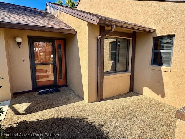 doorway to property with a patio area