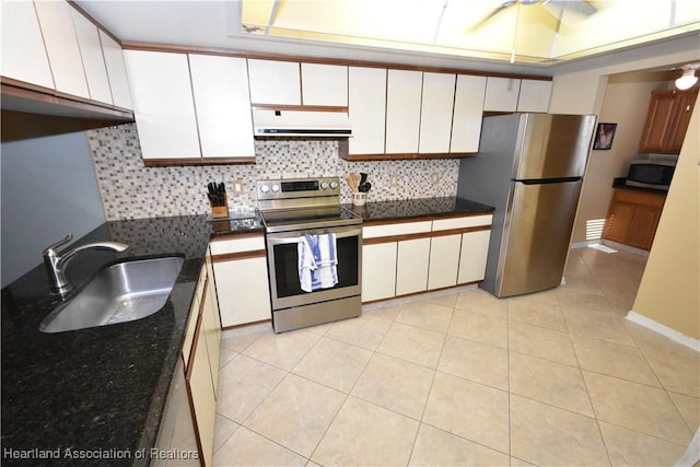 kitchen featuring white cabinetry, sink, decorative backsplash, light tile patterned floors, and stainless steel appliances