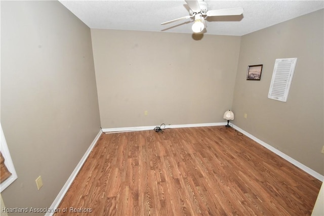 laundry area featuring wood-type flooring and ceiling fan