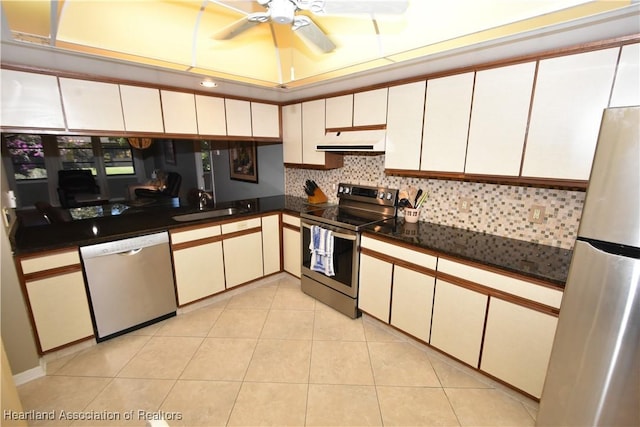 kitchen with sink, light tile patterned floors, stainless steel appliances, and white cabinets