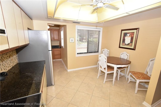 dining room with light tile patterned floors and ceiling fan