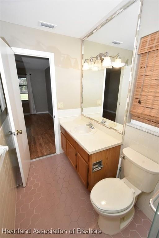 bathroom featuring tile patterned flooring, vanity, and toilet