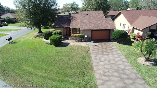 view of front of home with a garage and a front yard