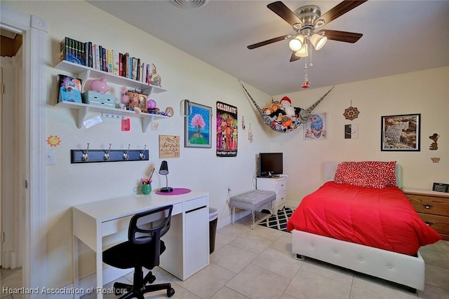 bedroom with a ceiling fan, baseboards, and light tile patterned floors