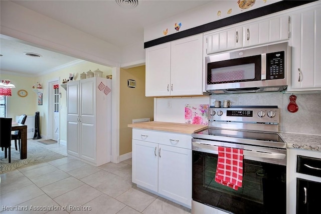 kitchen with stainless steel appliances, light countertops, visible vents, and white cabinetry