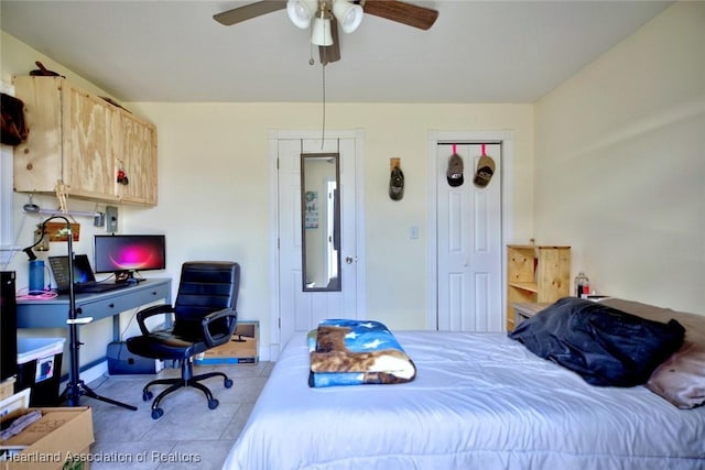 bedroom with a ceiling fan and tile patterned floors