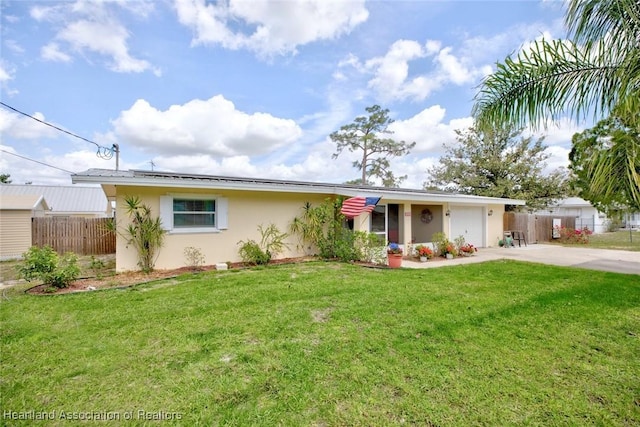 single story home with a front lawn, fence, an attached garage, and stucco siding