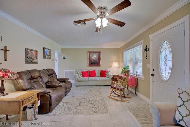 living area featuring light tile patterned floors, ceiling fan, visible vents, baseboards, and ornamental molding