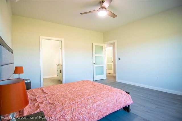 bedroom with ceiling fan, baseboards, and wood finished floors