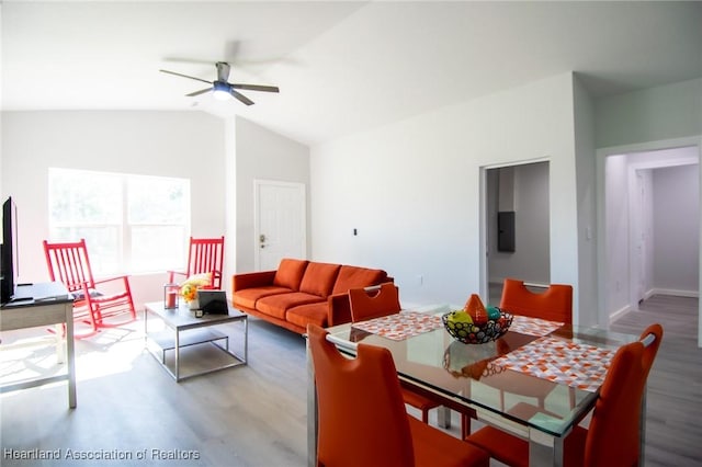 living area with lofted ceiling, electric panel, wood finished floors, and ceiling fan