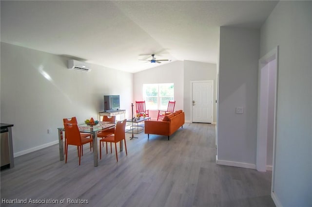 dining area with baseboards, a wall mounted air conditioner, lofted ceiling, wood finished floors, and a ceiling fan