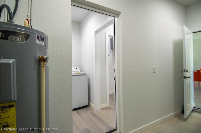 laundry area with washer / clothes dryer, wood finished floors, baseboards, and electric water heater